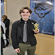 Teen standing with award