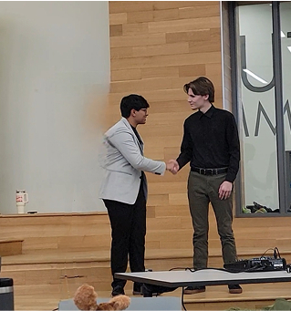 2 male teens shaking hands